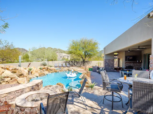 Stunning Cave Creek home with sparkling pool, spa, covered patio with shuffle board, outdoor dining, BBQ grill, fire pit, sun loungers, and private guest casita that features a sauna!