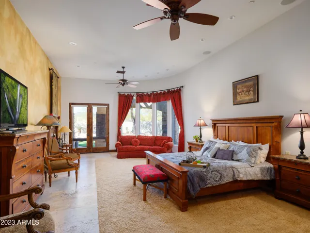 Primary bedroom with King bed, smart TV, lounge area, fireplace, and en-suite bathroom.