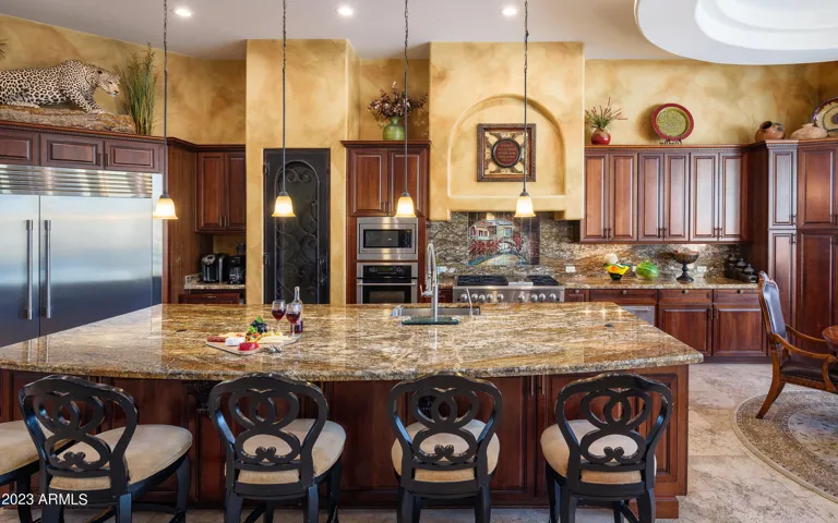 Stunning gourmet-style kitchen with stainless steel appliances, large island, breakfast table, and is fully equipped with your basic cooking essentials.