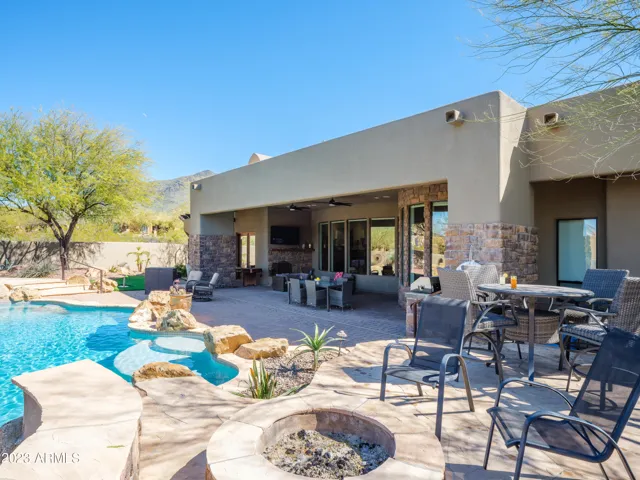 Stunning Cave Creek home with sparkling pool, spa, covered patio with shuffle board, outdoor dining, BBQ grill, fire pit, sun loungers, and private guest casita that features a sauna!