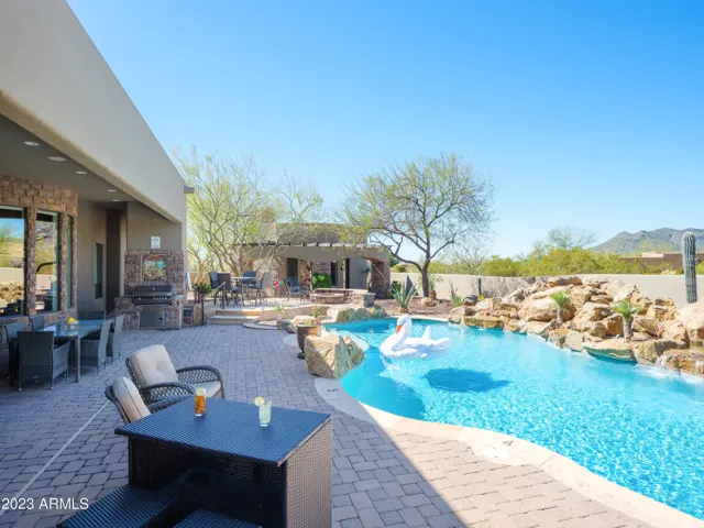 Stunning Cave Creek home with sparkling pool, spa, covered patio with shuffle board, outdoor dining, BBQ grill, fire pit, sun loungers, and private guest casita that features a sauna!