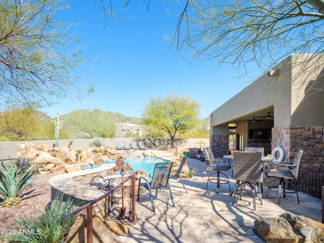 Stunning Cave Creek home with sparkling pool, spa, covered patio with shuffle board, outdoor dining, BBQ grill, fire pit, sun loungers, and private guest casita that features a sauna!