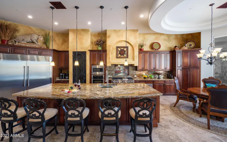 Stunning gourmet-style kitchen with stainless steel appliances, large island, breakfast table, and is fully equipped with your basic cooking essentials.