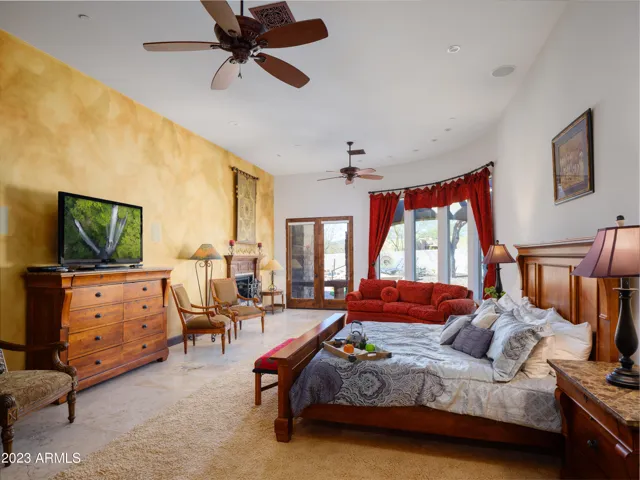 Primary bedroom with King bed, smart TV, lounge area, fireplace, and en-suite bathroom.