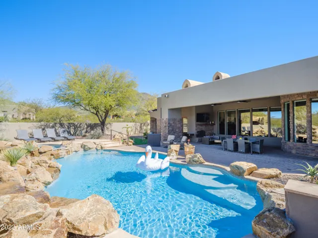 Stunning Cave Creek home with sparkling pool, spa, covered patio with shuffle board, outdoor dining, BBQ grill, fire pit, sun loungers, and private guest casita that features a sauna!