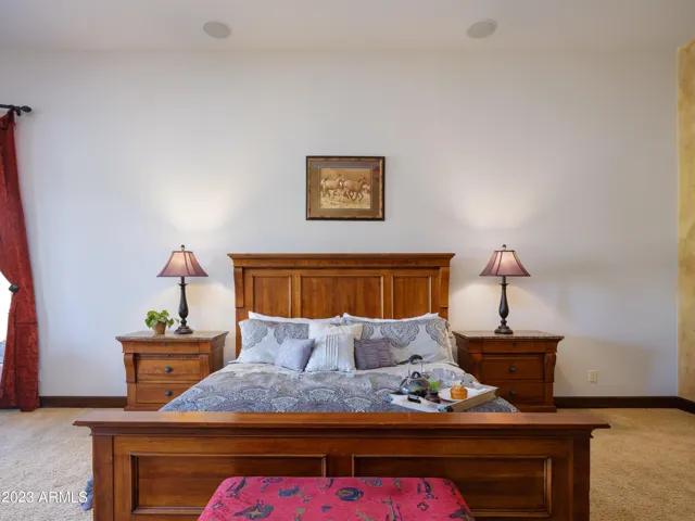 Primary bedroom with King bed, smart TV, lounge area, fireplace, and en-suite bathroom.