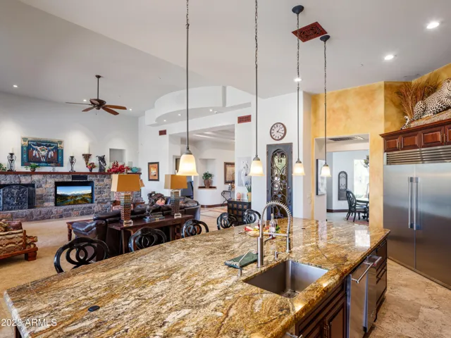 Stunning gourmet-style kitchen with stainless steel appliances, large island, breakfast table, and is fully equipped with your basic cooking essentials.