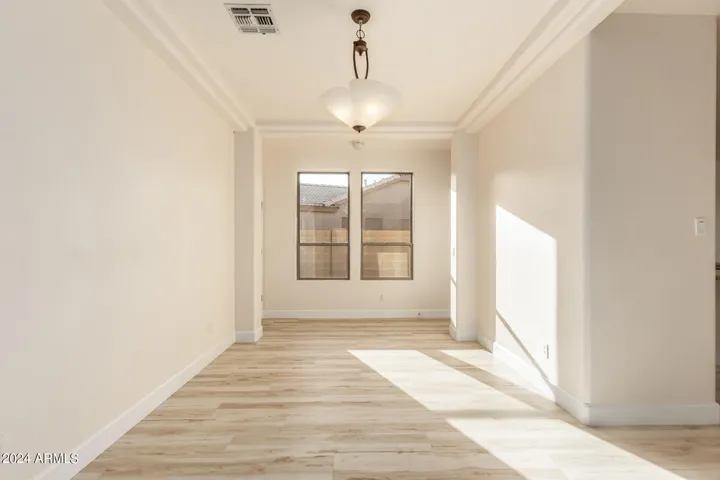 Formal dining by front entry.