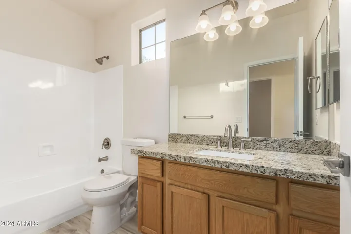 Hall bathroom with new granite,fixtures and toilet.