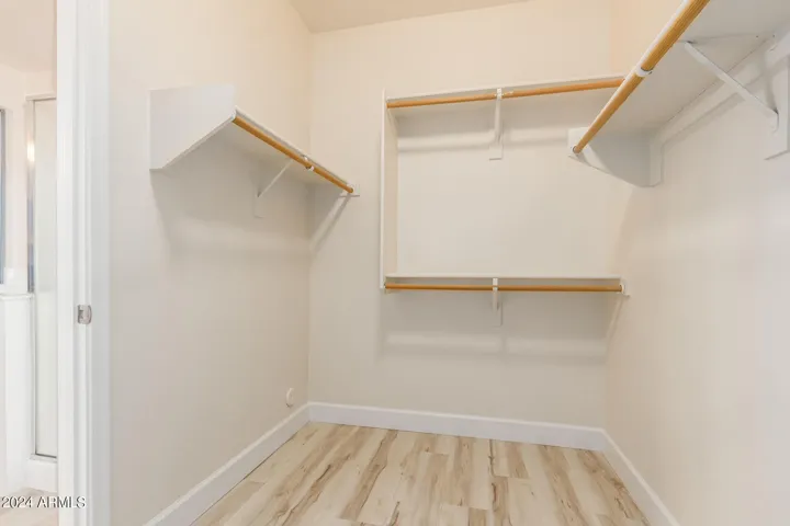 Primary bedroom walk in closet.
