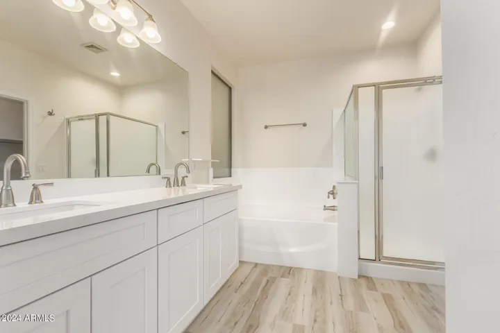 Primary bathroom has new vanity, fixtures and toilet.