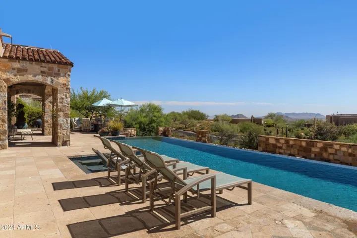 South facing Heated Negative Edge Pool w/Fire Feature, Spa, Splash Pad, Bocci Ball, Dual Patios, Automatic Lights, Mister Systems, Sound System and so much more!!!