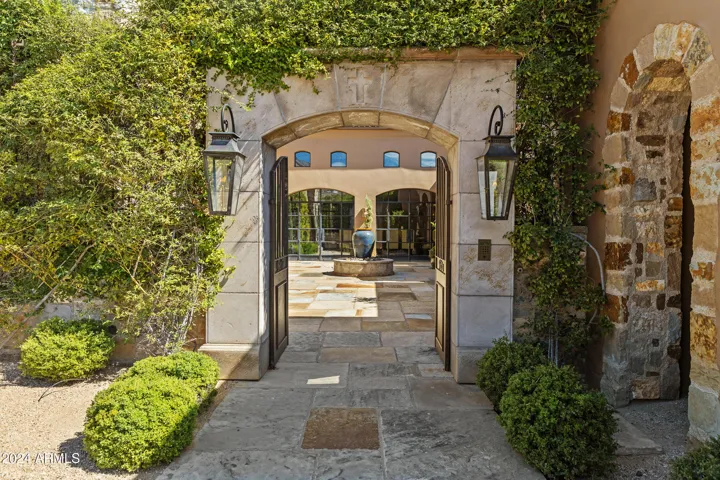Italian Courtyard with Fountain, Gas Fire Coach Lights, mature landscaping, tranquil gated entry.