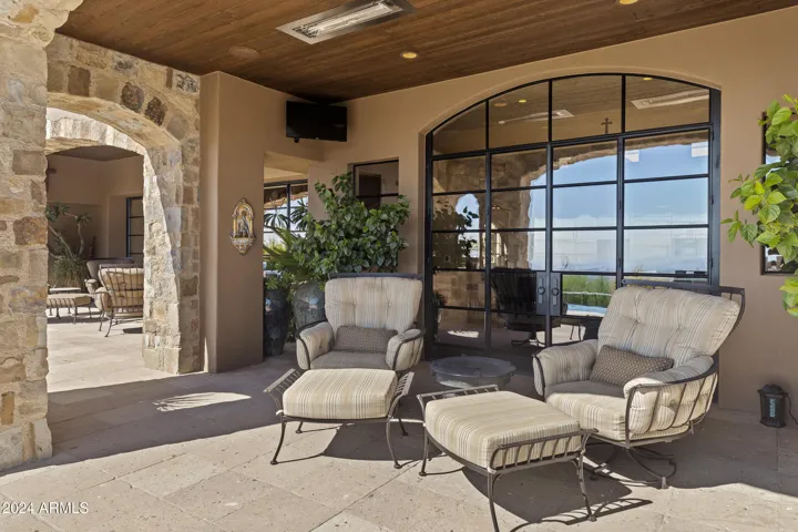 Back Patio facing South with Heated Negative Edge Pool w/Fire Feature, Spa, Splash Pad, Bocci Ball, Dual Patios, Automatic Lights, Mister Systems, Sound System and so much more!!!