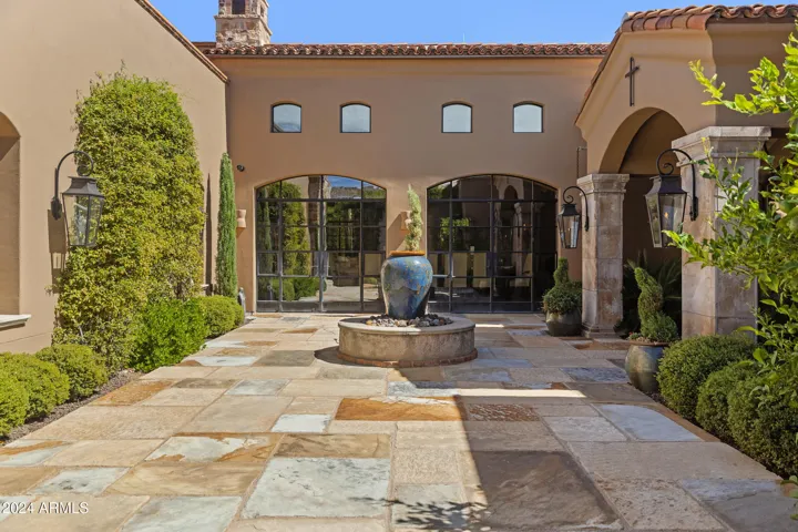 Italian Courtyard with Fountain, Gas Fire Coach Lights, mature landscaping, tranquil gated entry.