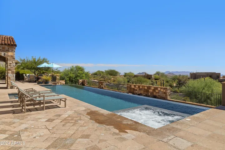 South facing Heated Negative Edge Pool w/Fire Feature, Spa, Splash Pad, Bocci Ball, Dual Patios, Automatic Lights, Mister Systems, Sound System and so much more!!!