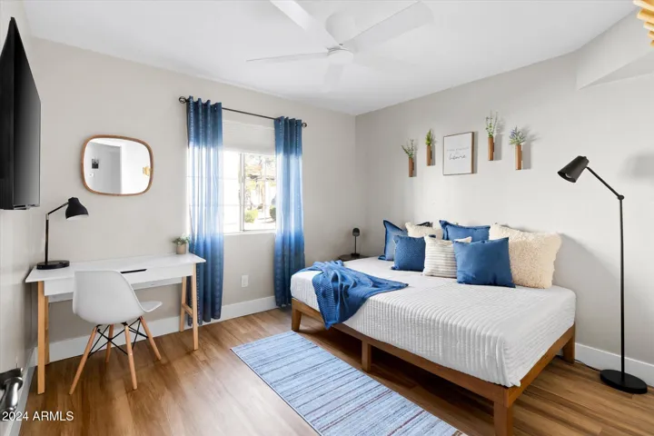 The second bedroom welcomes you with a full bed and workspace