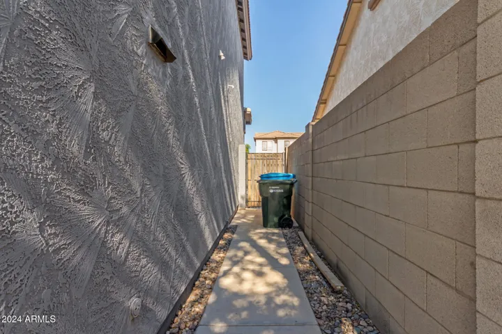 Concrete sidewalk to side gate