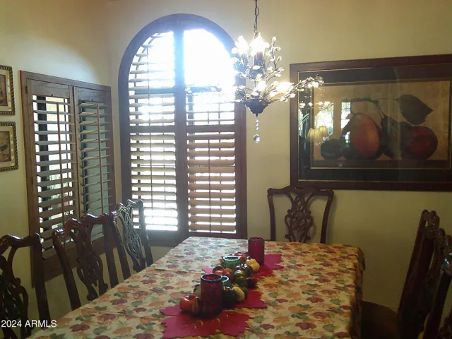 Formal dining room with massive, shuttered windows