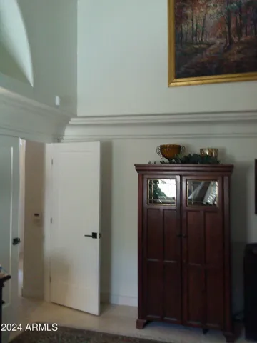 Music room has soaring ceilings. niches and alcoves
