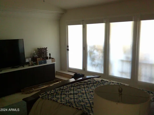 Huge windows overlook covered patio and the back yard
