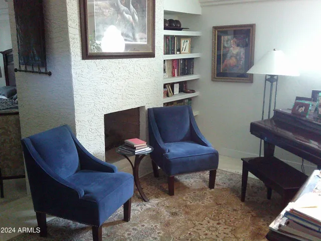 Music sitting room with fireplace adjacent to the primary building