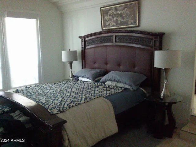 Primary bedroom has oversized king-sized bed in a 20 by 20 huge room