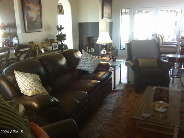 Great room has tongue and groove wood ceilings and two sided gas fireplace