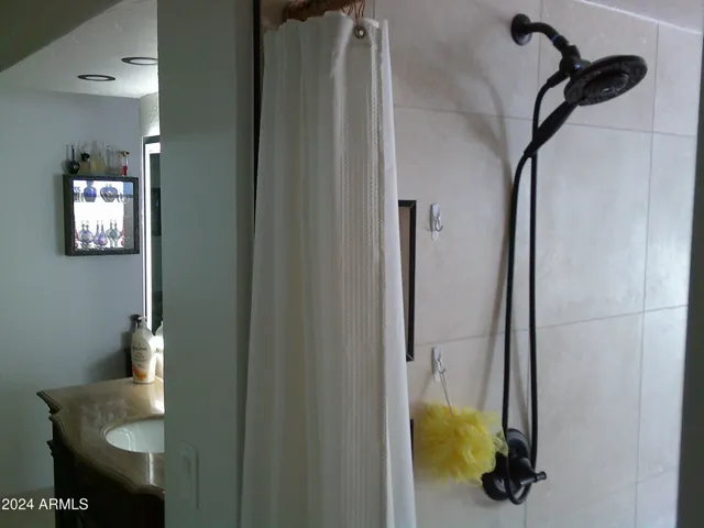 The primary bath has a "his" side and a "her" side