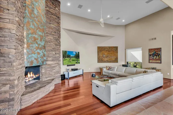 Experience the heart of the home in this stunning great room, where rich, warm wood floors set the stage for elegance and comfort. Anchored by a soaring copper fireplace, this space exudes character and warmth, offering the perfect blend of modern luxury and inviting charm.