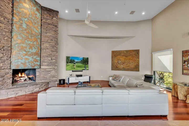 Experience the heart of the home in this stunning great room, where rich, warm wood floors set the stage for elegance and comfort. Anchored by a soaring copper fireplace, this space exudes character and warmth, offering the perfect blend of modern luxury and inviting charm.