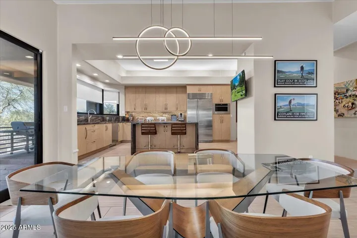 Step into this stunning open-concept dining and kitchen area, where modern elegance meets inviting warmth. Bathed in natural light, this bright and airy space features sleek finishes, high-end appliances, and a seamless flow perfect for entertaining or everyday living.