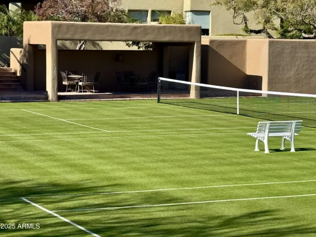 Meticulously maintained grass tennis courts are located within an easy 100-yard walk from the home at Desert Highlands #300