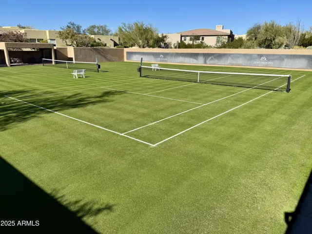 Meticulously maintained grass tennis courts are located within an easy 100-yard walk from the home at Desert Highlands #300
