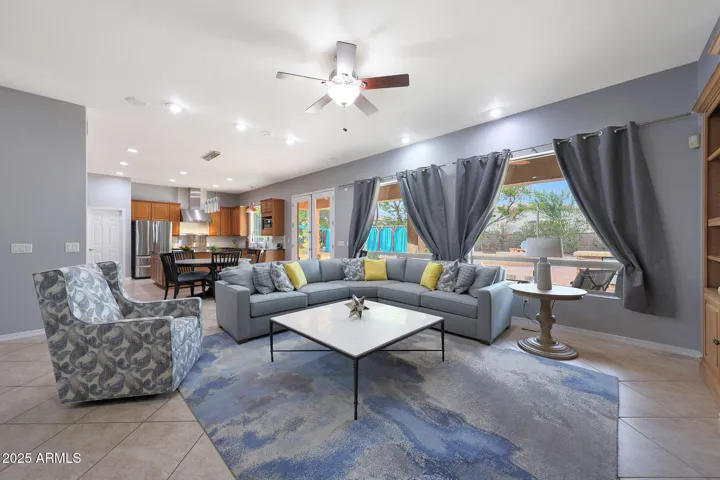OPEN AND AIRY, COMPLETE WITH NEUTRAL COLORS AND SPACE FOR ENTERTAINING. ROOM EASILY ACCOMADATES LARGE GROUPS OF PEOPLE AND ENTERTAINING. WET BAR NOT SHOWN BUT IN BACKGROUND ALSO WITH PRIVATE ROOM FOR BOTH STORAGE, KID SPACE, PET AREA(ACCESS TO DOG DOOR)