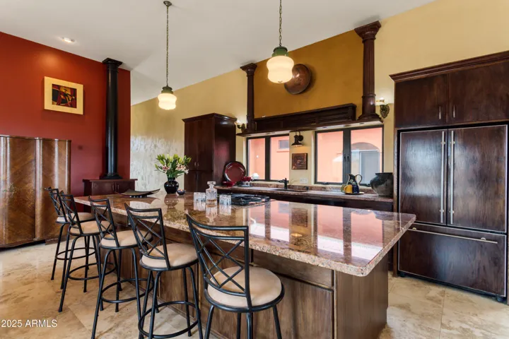 Dramatic light fixtures above enormous island.