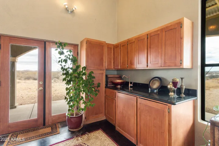 Kitchenette with fridge, dishwasher, bowl sink.