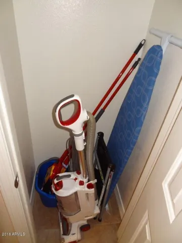 Vacuum, ironing board, cleaning supplies