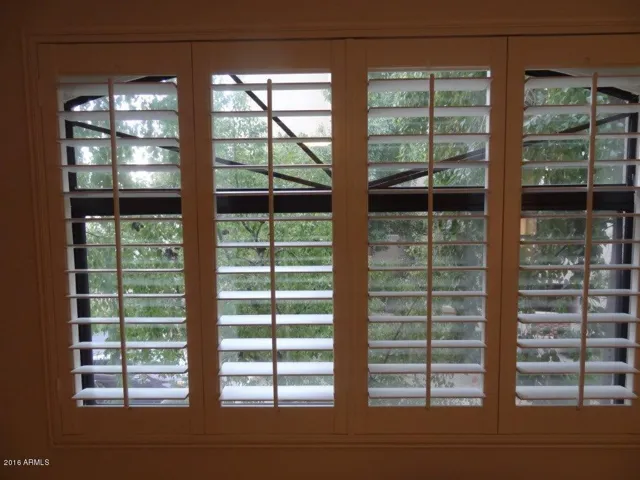 Plantation shutters in primary bedroom
