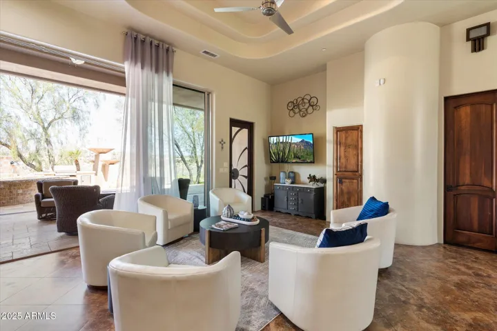 Relax in the spacious family room featuring modern design, patio access, and an inviting atmosphere for casual gatherings.