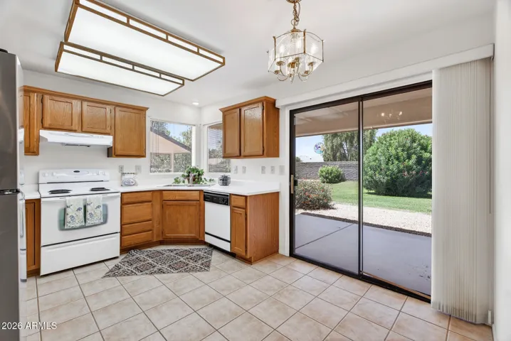 The light bright kitchen offers space for a small table & chairs.