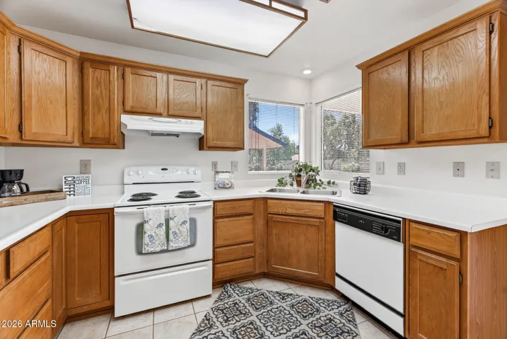Enjoy looking out the window onto the grassy back yard while doing the dishes.