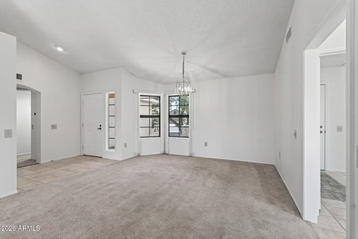 This is a Great Room/Dining area with vaulted ceiling.