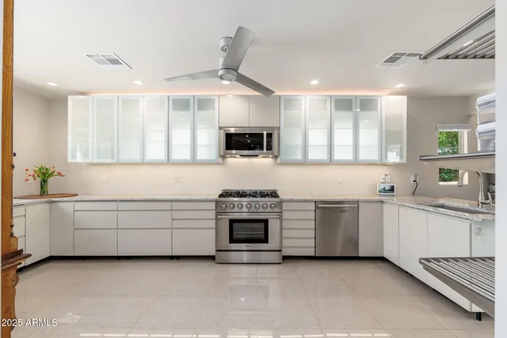 A kitchen designed for chefs with high end 6 burner gas range and oversized microwave