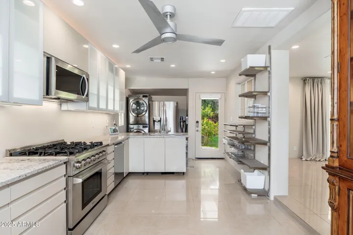 Slight step down into a gorgeous kitchen with open direct backyard access.