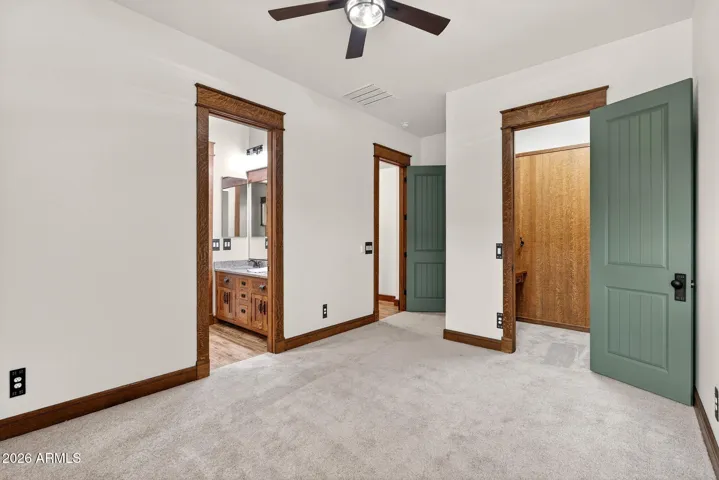 With fresh carpet, high ceilings, and Stickley-style trim, this secondary bedroom offers comfort and charm. Perfect for guests, kids, or home office space in this upgraded Arizona bungalow.