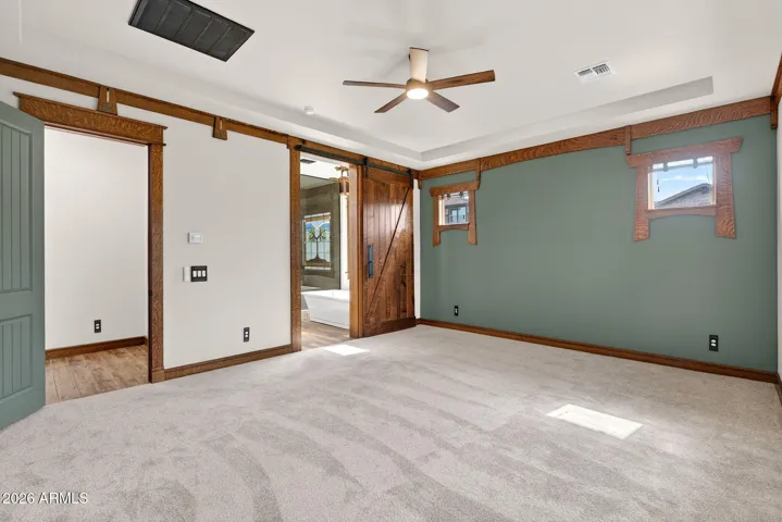 Wake up to desert sunshine in this spacious owner’s suite, complete with large windows, tray ceiling, and access to the beautifully landscaped backyard—designed for everyday luxury.