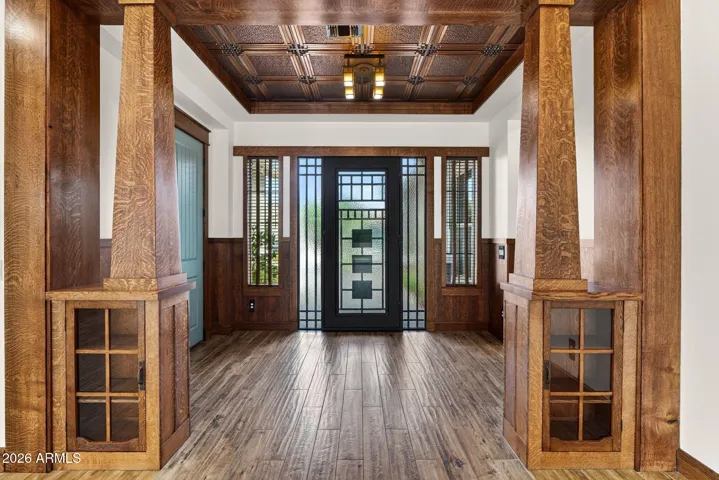 Make a lasting first impression with this stunning entryway, featuring custom millwork, period lighting, and quarter-sawn oak columns. The detail pays homage to classic Arts & Crafts design.