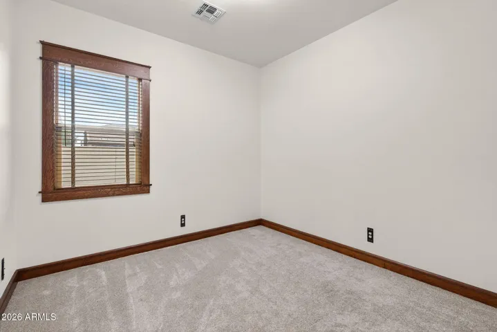 This inviting flex space offers privacy, comfort, and stylish trim—ideal for a home office, den, or guest bedroom in this energy-efficient, Craftsman-style home.