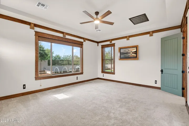 Wake up to desert sunshine in this spacious owner’s suite, complete with large windows, tray ceiling, and access to the beautifully landscaped backyard—designed for everyday luxury.